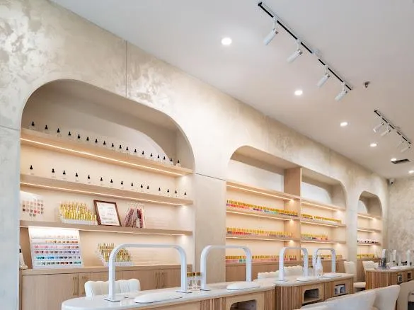 Commercial spa fit-out: pedicure stations with brass fixtures against hand-applied plaster walls